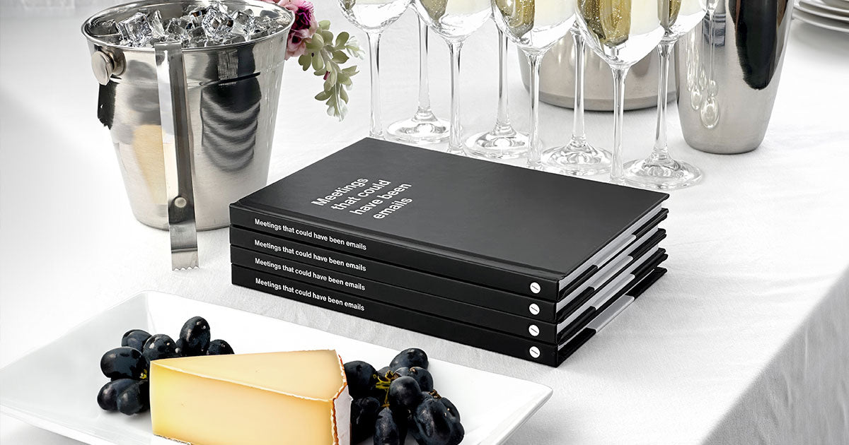 A pile of funny WTF Notebook corporate gifts at a business event