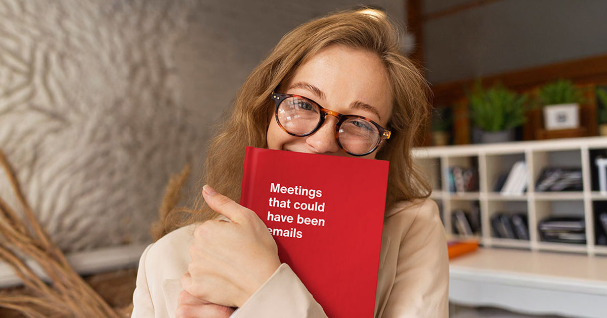 A young woman hugging her funny ADHD-humor gift WTF Notebooks