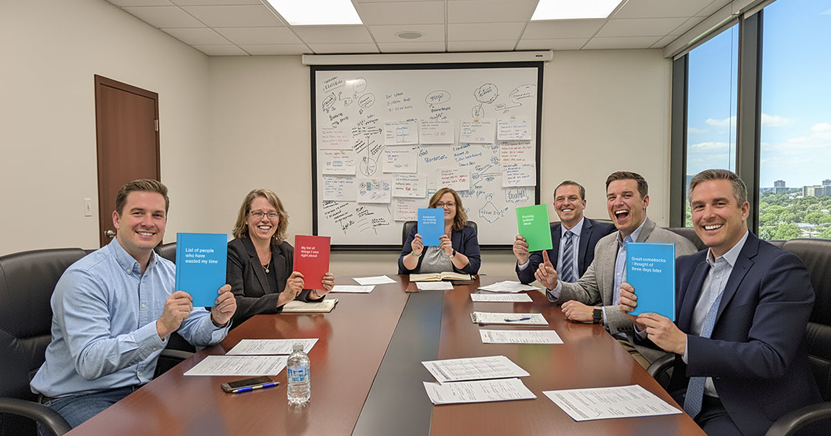 An office team during a meeting presenting their funny WTF Notebook staff gifts