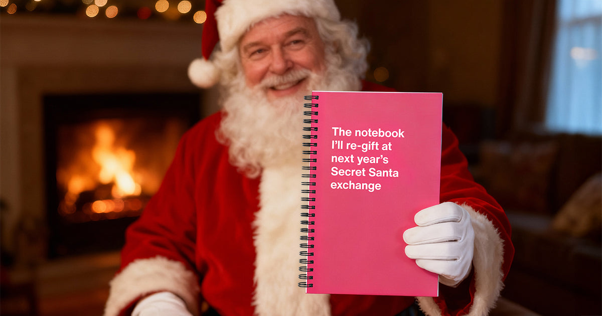 Santa holding up a funny WTF Notebook entitled