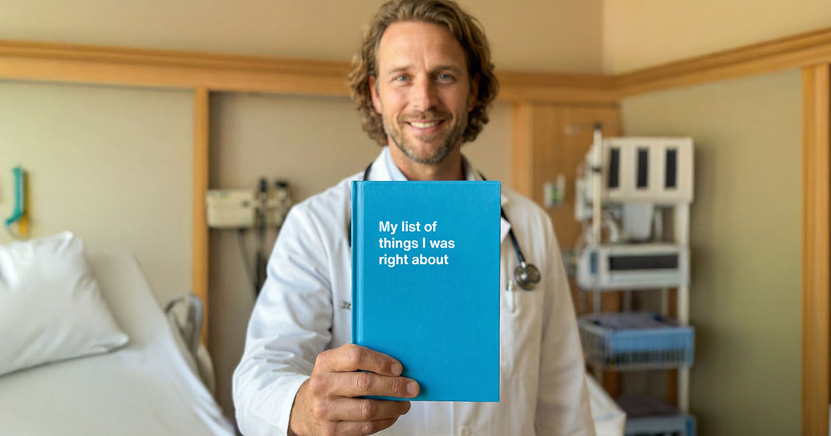 A doctor holding up his funny WTF Notebook healthcare gift