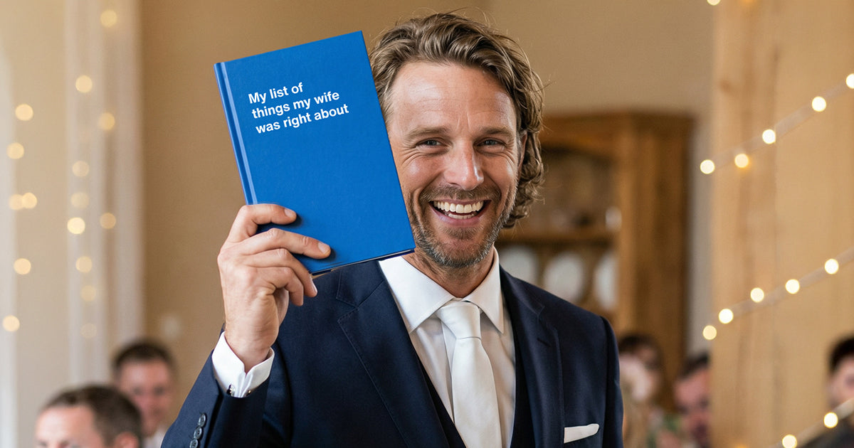 A groom holding up his funny wedding gift WTF Notebook